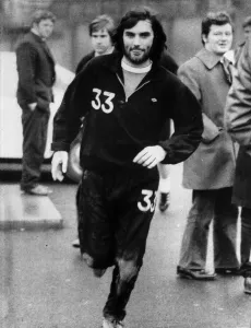 Sporting Legend Prints: George Best Manchester United footballer returning wearing track suit after missing