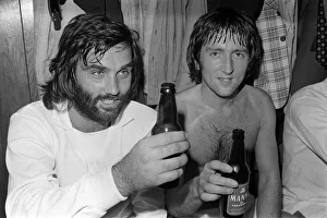 Dressing Room Prints: George Best former Manchester United player sitting in dressing room holding a bottle of