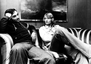 George Best and Rodney Marsh together on sofa circa 1976 who are both playing together