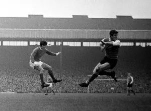 George Best shoots at goal for Manchester United past Sheffield Wednesday defender Johnny