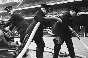 George Greenwell carrying hose (right) with Guy Bartholomew Editorial Director of