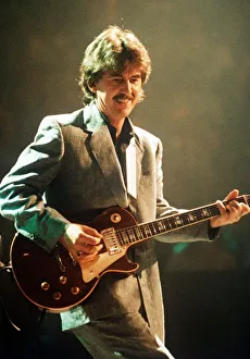 George Harrison ex Beatles Playing the guitar at the Gary Moore concert at the Royal