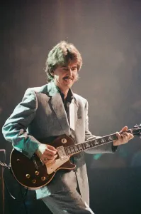 George Harrison ex Beatles Playing the guitar at the Gary Moore concert at the Royal