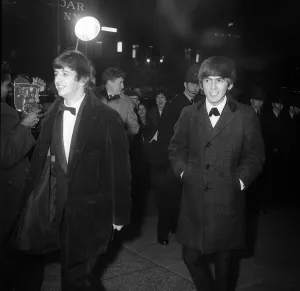 George Harrison and Ringo Starr smile as the group arrive at the Empire Ballroom in