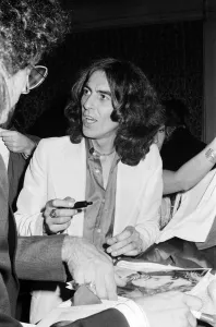 Launch Prints: George Harrison signs posters for his new album Thirty Three & 1 / 3