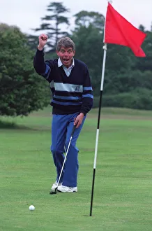 Hole Prints: George King celebrates his scratchcard jackpot on the golfcourse after he