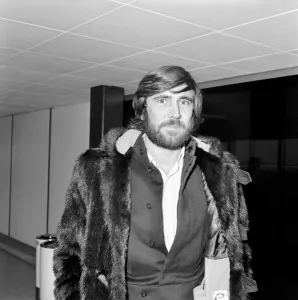 George Lazenby arrived at Heathrow Airport today from San Francisco