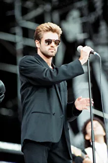 Black Suit Prints: George Michael performing on stage at the Nelson Mandela 70th Birthday Tribute concert