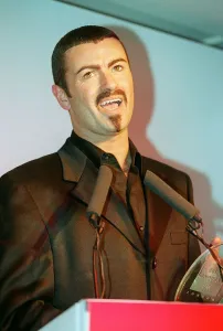 George Michael the singer collects his award at the Help A London Child