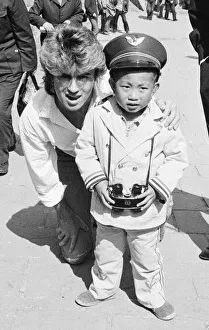 Binoculars Prints: George Michael from Wham ! and a Chinese Boy on The Great Wall of China, in China. 1985