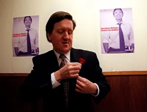 George Robertson at the Labour Party Press Conference looking downwards as he places red