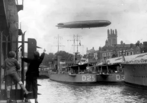 Docks Prints: German airship Graf Zeppelin flies over Bristol docks and the destroyer HMS Warwick (D25