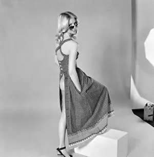 German glamour model Maureen wearing a sleeveless open backdress. April 1975