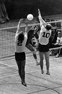 Gerry Coatbridge, of Coatbridge, smashes the ball back across the net as Ian Thompson (2