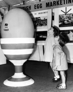 Amazement Prints: A giant egg brings amazement and wonder to the faces of two children at the British Egg