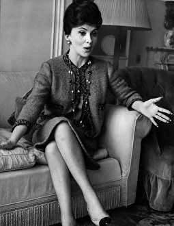 Gina Lollobrigida Italian actress Sitting on a sofa talking