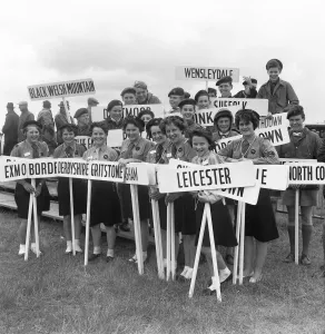 Youth Movement Prints: Girl Guides and Scouts holding their home town signposts at the opening of The Royal