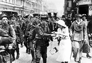 Girl selling Help France flags to British troops going to war 1915
