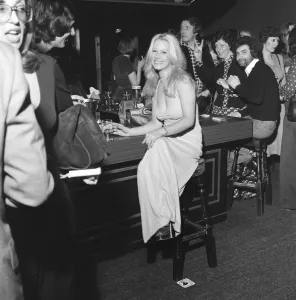 A girl sitting alone at the bar inside the nightclub Slack Alice in Manchester which