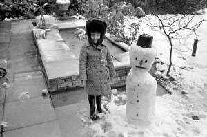 Images Dated 30th March 1975: A girl with the snowman she built during the last fall of snow. March 1975 75-1706-012