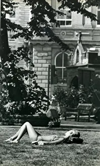 00066 Prints: A girl sunbathes in St. Johns churchyard in Newcastle during the long hot summer in