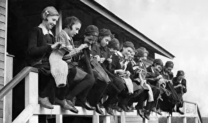 Knitting Prints: Girls at the Finnermore wood camp huts are here seen knitting sea stockings