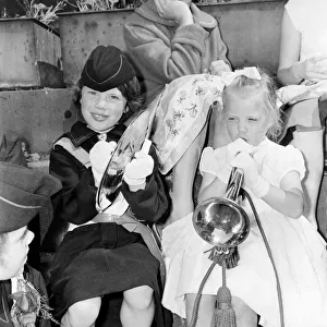 00041 Prints: To girls taking part in the Manchester Whit Walks trr their hand at the trumpet