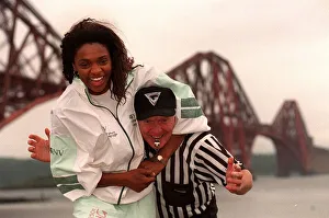 Gladiator Rocket ( Pauline Richards) gets a head lock on referee John Anderson with