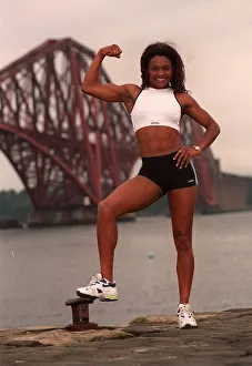 Gladiator Rocket (Pauline Richards) showing her muscles with the Forth railway bridge in