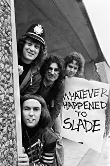 November Collection: Glam rock group Slade posing for pictures in Birmingham City Centre. 25th March 1977