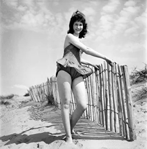 Glamour Girl. Barbara Stockton, 19 seen here posing on the beach. June 1960 M4295