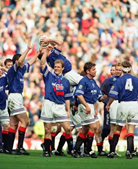 Glasgow Rangers footballer Paul Gascoigne kisses the match ball as he celebrates Rangers