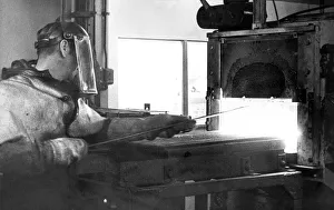 Glass blower Bob Hall unloads a furnace burning at 1800 degrees centigrage