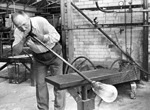 Glass blower Bill Tremble is tube drawing a glass bulb in July 1987