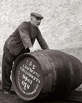 Whiskey Prints: A Glenlivet Distillery worker in Scotland rolls a barrel of their finest single malt