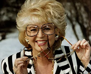 Gloria Hunniford TV Presenter holding glasses in hand voted spectacle wearer of the Year