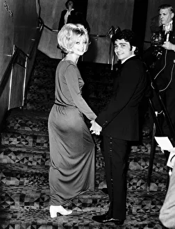 Goldie Hawn Actress holding hands with her husband Gus Trikonis at a film premiere in