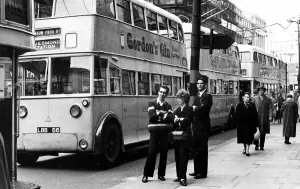 A good time for a chat when trolley bus drivers and a conductress take a break as