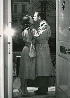 Houses And Homes Prints: Goodnight kiss on the doorstep: Ian Carmichael and Janette Seatt exchange a tender kiss