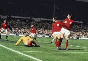 Gordon Banks dives to save the ball. Also in the penalty area watching from left to right