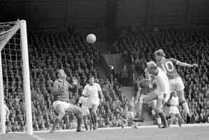 Goalkeeper Prints: Gordon Wallace of Liverpool leaps high to win the ball with a header against the Arsenal