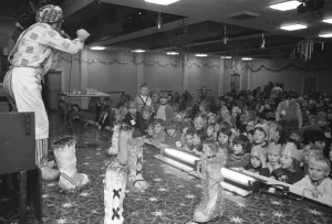 00098 Prints: Bill Gore, the singing cobbler, entertains children at a party in the Lockhead ballroom