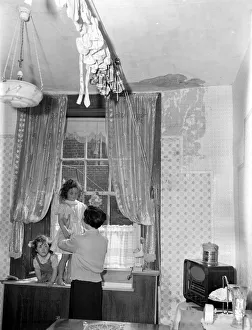 A Govan mother seen here undressing her two daughters for a bath in the kitchen sink as