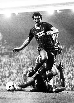 Graeme Souness of Liverpool jumps over Brighton goalkeeper Graham Mosely during the two