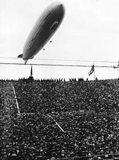 Arsenal Prints: The Graf Zeppelin passing low over Wembley Stadium during the FA Cup Final in which