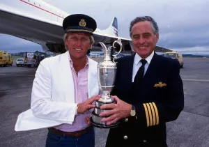White Jacket Prints: Greg Norman holds the Claret Jug trophy after winning the British Open with Concorde