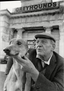Derbyshire Prints: Greyhound trainer with his dog No Stranger at the last meeting at the Derby Greyhound