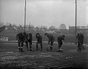 Grounds staff at Bristol Rovers Eastville Stadium struggle to clear snow from the pitch