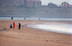 00088 Prints: A group of anglers enjoying a spot of fishing on the beach at South Shields