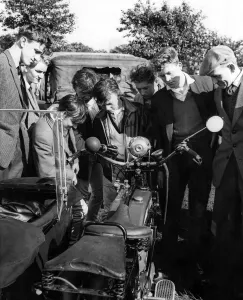 Annual Prints: A group of boys and men looking at a motorcycle during the Tyneside Summer Exhibition